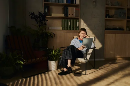 Image of a woman in a study, deeply focused while reading content on her reMarkable paper tablet."